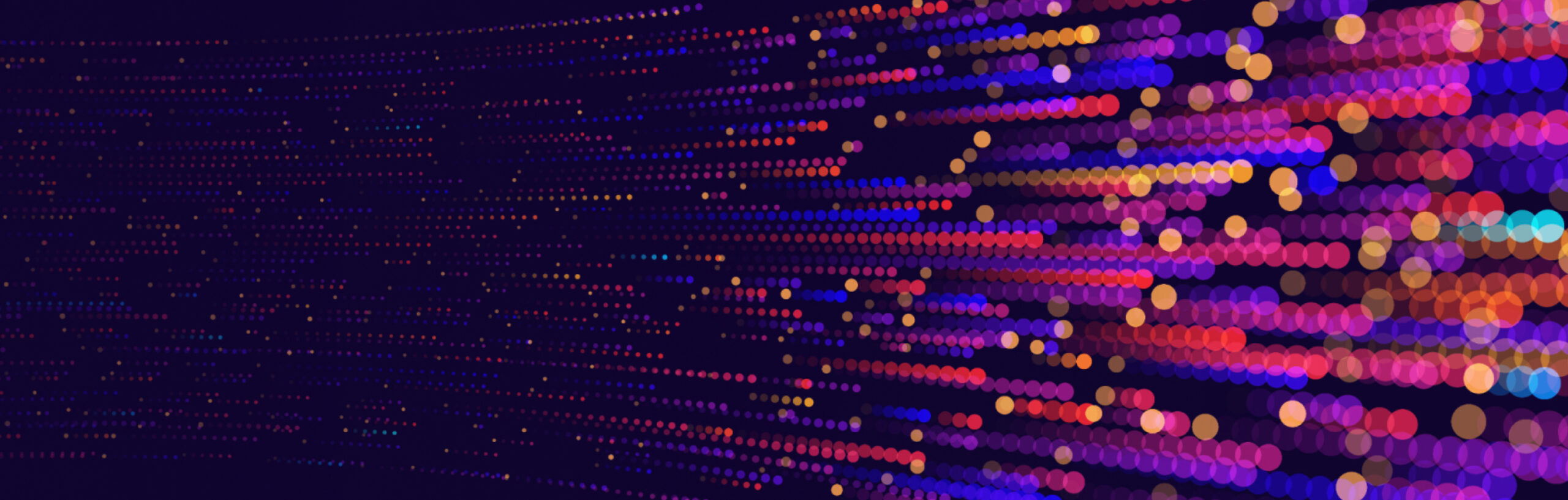 A digital abstract image with colorful dots in varying sizes and shades of purple, pink, and yellow, arranged in a pattern against a dark background.